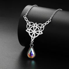 ⚜️Looking for a stunning piece of jewelry that exudes both style and spirituality? Look no further than our Celtics Knot Necklace! Crafted with Stainless Steel and adorned with a mesmerizing Crystal Rhinestone, this necklace will add a touch of magic to any outfit. Complete with an elegant pendant size of 32.5*27.9mm, it's the perfect accessory for any witch or crystal lover. Add it to your collection today and let its powerful energy guide you on your journey! ✨🔮 Mystical Amethyst Necklace For Gift, Mystical Amethyst Crystal Necklace With Gemstones, Mystical Amethyst Crystal Necklace Gift, Witch Pendant Necklace, Witch Knot, Celtic Witch, Triple Moon Goddess Necklace, Crystal Witch, Celtic Knot Necklace