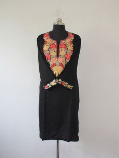 Embrace effortless elegance with a Kashmiri Aari embroidered cotton kurti.The cool, breathable comfort of cotton is elevated by the meticulous artistry of Aari work. This traditional embroidery technique utilizes a long needle to create stunning designs directly onto the fabric. Imagine delicate floral patterns, geometric motifs, or even enchanting paisleys adorning the kurti, each stitch imbued with the skill of Kashmiri artisans. The result is a garment that's both beautiful and versatile, perfect for adding a touch of cultural flair to your everyday wardrobe. Product Details - Condition: Brand New - Handmade - Style: Kurti Tunic - Fabric: Ruby Cotton - Embroidery: Kashmiri Aari Embroidery - Embroidery Color: blue - Kurti Length: 42" Inch - Kurti Chest: 42'' Inch - Care Instructions: Han Designer Floral Embroidery Kurta For Transitional Season, Designer Floral Embroidered Kurta For Transitional Season, Diwali Traditional Wear Straight Kurta With Embroidered Neckline, Traditional Sets With Embroidered Neckline For Festivities, Anarkali Traditional Wear With Embroidered Neckline For Designer Wear, Traditional Festive Sets With Embroidered Neckline, Multicolor Embroidered Cotton Silk Kurta For Transitional Seasons, Cotton Silk Kurta With Multicolor Embroidery For Transitional Season, Traditional Salwar Kameez With Embroidered Neckline