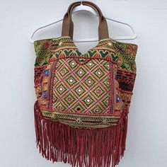 Lauren' Fringe Hobo Bag In Warm Multidecked Out In Colorful Fringe And A Patchwork Of Luxe Textures, This Globe-Trotting Hobo Goes Anywhere In Style. By Sam Edelman. Large Sized Bag; 14"W X 12"H X 4-1/2"D Interior Features 1 Zip Pocket And 2 Slip Pockets 7-1/2"L Double Handles Top Zip Closure Exterior Features Gold-Tone Hardware And Hanging Fringe Silhouette Is Based Off 5'9" Model Cotton; Trim: Leather; Fringe: Suede. Please Look At The Last Picture For The Minor Scratches Multicolor Double Handle Hobo Bag For Errands, Multicolor Leather Bags For Summer, Multicolor Hobo Bag With Leather Handles For Errands, Multicolor Tote Hobo Bag For Errands, Multicolor Hobo Bag With Detachable Handle For Shopping, Traditional Summer Bags With Leather Handles, Red Bohemian Bucket Bag For Travel, Bohemian Tote Bag For On-the-go, Yellow Bohemian Shoulder Bag For Shopping