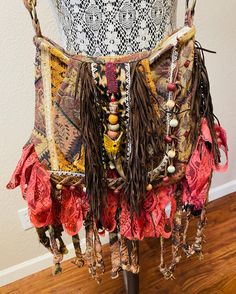 Here is a boho hippie fringe handmade shoulder, crossbody or messenger bag. I am a including a small wristlet that coordinates with this purse as a bonus. All my materials are upcycled and or vintage. The body of both bags started life as a Pier One bed spread that was made in India. The fringe is faux suede. I have embellished the front flap with beads and a sustainably gathered deer antler. The inside of both bags are lined. The large bag has 3 interior pockets and the small wristlet has a small pocket to tuck in a key. All the measurements are in my photos. Brown Hobo Bag For Festival, Bohemian Brown Shoulder Bag, Bohemian Brown Hobo Bag, Handmade Hippie Shoulder Bag For Festival, Hippie Handmade Shoulder Bag For Festival, Hippie Handmade Festival Shoulder Bag, Handmade Crossbody Hobo Bag For Festivals, Hippie Brown Hobo Bag For Festivals, Bohemian Upcycled Multicolor Shoulder Bag