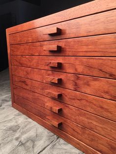 a close up of a wooden dresser with many drawers on it's front and side