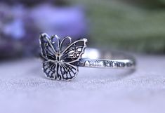 This listing is for one beautifully intricate and dainty sterling silver butterfly stacking ring. It features one detailed butterfly fired onto a elegant and feminine dotted ring band. This ring is perfect for all butterfly lovers and makes a great spring and summer ring! It looks great solo or stacked with other rings and bands. - Choose your size at check-out! - Butterfly measures 9mm by 9mm. - Ring band is 1.5 mm tall. Want the entire butterfly stacking set? Check it out here: https://www.ets Delicate Adjustable Butterfly Promise Ring, Elegant Sterling Silver Rings With Butterfly Charm, Elegant Silver Jewelry With Butterfly Print, Dainty Adjustable Silver Butterfly Ring, Delicate Silver Butterfly Open Ring, Delicate Silver Butterfly Ring, Bohemian Butterfly Ring As A Gift, Delicate Silver Butterfly Promise Ring, Bohemian Butterfly Ring As Gift