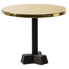 a round table with two black pedestals and a gold plated top on it