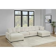 a living room with a large white sectional couch