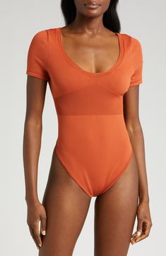 Keep it sleek with a ribbed bodysuit dipped low at the neck and even lower at the back. Adjustable back strap Deep V-neck Short sleeves 67% polyester, 33% nylon Machine wash, line dry Imported Sleek Scoop Back Swimwear For Summer, Solid Color Smoothing Leotard For Summer, Chic Summer Bodysuit With Scoop Back, Summer Leotard With Smoothing Feature, Summer Second-skin Leotard With Scoop Back, Summer Leotard With Scoop Back And Second-skin Fit, Chic Seamless Summer Leotard, Second-skin Scoop Back Leotard For Summer, Summer Smoothing Leotard