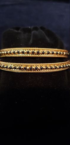 "* Handcrafted Gold Plated 2 Bangle Set. Sold as a set. * Bangles with prettY Black and gold color beads. * High Quality 22 K Gold Plated- 2 Bangle set * Size 2.6 has 2.40\" inner circle diameter; size 2.8 has 2.53\" inner circle diameter Gorgeous gold-plated bangle/ bracelet best exemplifies the careful craftsmanship done on it -- a specialty at Nemali Jewelry. It has a special tone of elegance attached to it. The intricate handmade design of the bangle/bracelet set gives it a fresh and origina Gold Beaded Bangle Jewelry, Gold Beaded Bangle For Wedding, Gold Beaded Bracelets With Tiny Beads For Party, Festive Gold Jewelry With Tiny Beads, Gold Beaded Chain Bangle Jewelry, Gold Bangle With Tiny Beads, Gold Beaded Bangle Bracelet, Gold Beaded Bangle As Gift, Adjustable Gold Bangle With Round Beads