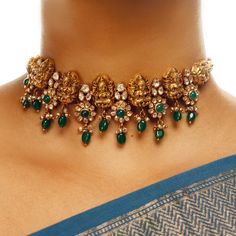 The Neema Lakshmi Floral Choker is an antique southern temple-inspired design featuring Lakshmi motifs surrounded by beautiful flowers in a choker pattern. Perfect for layering with our long haars. Luxury Women's Temple Jewelry Choker, Traditional Luxury Necklaces With Motifs, Layered Haram Gold, Kundan Choker Necklace Gold, Indian Emerald Jewellery, Emerald Necklace Indian Gold Jewellery, Antique Choker Designs, Temple Jewellery Choker, Latest Gold Choker Necklace Designs