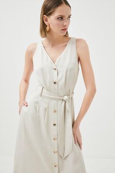 {@@=Ist.Core.Helpers.StringHelper.ToProperCase("With a simple but feminine feel, this light linen-mix midi dress was made for sun-soaked sojourns. It shows off a neat row of glossy buttons, waist-cinching belt and V-neckline to show a hint of skin. Draping elegantly to a mid-calf length, seductive hem splits provide a sense of light airiness whilst practical slip pockets frame the sides for a subtle utilitarian feel.Expertly designed for those 5'3" and under, our Petite pieces are perfectly prop V-neck Linen Midi Dress With Belt, Linen Midi Dress For Day Out, Beige Linen Midi Dress For Spring, Chic Button-up Linen Dress, Summer Button Closure Midi Dress For Day Out, Summer Midi Dress With Button Closure For Day Out, Chic Beige Midi Linen Dress, Chic Button-up Linen Dress For A Day Out, Spring Beige Belted Dress With Tie Waist