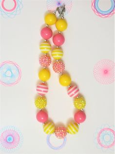 "-  Pink, and yellow chunky beads with silver spacer and sparkle beads -  Your little girl or toddler will look like a Princess in this beautiful, fun, Chunky Bubblegum Necklace. -  This necklace would be the perfect dazzling addition for your little Princess outfit to wear for any special occasion. -  Necklace length 17\"  Materials:  acrylic beads, resin beads, bead wire, crimp tubes, jump rings, stainless steel clasps **Custom Orders Are Welcome** Ready to ship in 1 to 3 business days by USPS First Class Mail. - Returns & Exchanges I do accept returns and exchanges.  Just mail it back to me within 7 days of delivery. WARNING The jewelry is made with small beads and small parts.   Please do not leave your child unattended while wearing the jewelry.  By purchasing the jewelry you are agre Yellow Fun Jewelry With Colorful Beads, Fun Yellow Jewelry With Colorful Beads, Playful Round Beads Necklaces For Parties, Cute Yellow Jewelry With Colorful Beads, Cute Adjustable Yellow Necklace, Cute Adjustable Yellow Necklaces, Fun Yellow Jewelry For Birthday, Cute Yellow Round Bead Necklaces, Playful Yellow Necklaces With Colorful Beads