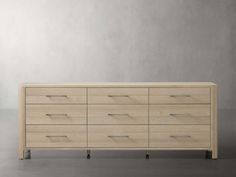 a large wooden dresser sitting on top of a gray floor next to a white wall