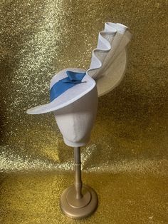 "This stunning 1930's inspired sun hat with has been hand blocked in a lovely ivory straw. The fabulous asymmetric brim elegantly elongates at one side and has been gently folded into a beautiful deco fan detail which swoops us up to reveal the side profile of the face, creating an elegant and feminine silhouette.  Trimmed with a bold blue vintage gros grain hat band and tailored bow.... Perfect for any summer party!  Fixed with elastic for extra security and sent with a lovely vintage hat pin. this hat has been made to fit a 22 -22.5\" head so please be sure to measure your head to make sure it will fit before making your purchase" Fitted Sinamay Straw Hat With Curved Brim, White Fitted Brimmed Panama Hat, Fitted Cream Panama Hat With Short Brim, Fitted Sinamay Boater Hat With Curved Brim, White Fitted Panama Hat With Curved Brim, Elegant Boater Hat With Curved Brim In Toquilla Straw, Elegant Sun Hat With Curved Brim In Toquilla Straw, Elegant Toquilla Straw Sun Hat With Curved Brim, Fitted White Toquilla Straw Sun Hat