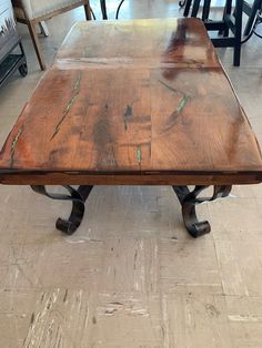 a wooden table sitting on top of a hard wood floor