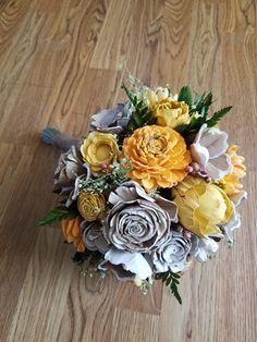 a bouquet of flowers sitting on top of a wooden floor