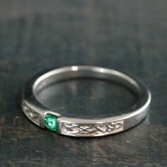 Men's Engagement Ring Celtic Band Emerald Ring Men's Celtic Band Women's Celtic Wedding Ring Celtic Knot Ring Irish Wedding Band Silver This simple Celtic Band reaches a new level with a 3mm channel set round emerald! The band itself is solid Sterling Silver and measures 3mm at the front, tapering to just over 2mm in the back, making it a very comfortable to wear band. It is a chunky 3mm thick in the front and thins to 1.5mm thick in the back. The Celtic knotwork relief carvings accent the stone Classic Polished Emerald Ring For Wedding, Classic Polished Emerald Wedding Ring, Polished Emerald Ring For Wedding, Adjustable Emerald Wedding Ring May Birthstone, Wedding Birthstone Ring With Polished Finish, Adjustable Emerald Birthstone Ring For Wedding, Wedding Birthstone Ring With Polished Round Cut, Adjustable Wedding Ring With May Birthstone, Adjustable Wedding Emerald Ring For May Birthstone