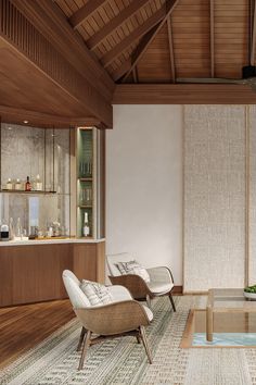 a living room with two chairs and a coffee table in front of a wall mounted shelf