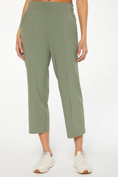 With a high stretch content for maximum mobility, these cropped, relaxed-fit pants feature a comfort waistband with an elasticized back and convenient side pockets for your phone, cards, and keys. Brand: Marika 76% Nylon / 24% Spandex 12" Front Rise / 15¾” Back Rise 25" Inseam (Size M) 2" Encased Elastic Waistband Relaxed Fit Front Seam Pockets Machine Wash Color: Agave Green Green Stretch Elastane Pants, Solid Color Activewear With Comfort Waistband For Work, Spring Comfort Stretch Pants With Side Pockets, Spring Pants With Comfort Stretch And Side Pockets, Spring Pants With Side Pockets And Comfort Stretch, Versatile Elastane Pants With Pockets, Solid Color Straight Leg Activewear With Side Pockets, Functional Bottoms With Elastic Waistband For Work, Functional Ankle Pants With Pockets