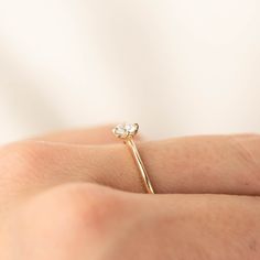 0.25ct brilliant cut diamond, 4mm, near colorless, eye clean 0.50ct GIA certified Excellent cut grade G color SI1 clarity (Made to order) Band width: approx. 1.1mm to 1.4mm tapered band High profile four prongs flower setting Made of 100% recycled solid 14k yellow gold and ethically sourced gemstone Alice ring is minimal and dainty, features 0.25ct brilliant cut diamond in our signature flower setting. The tapered band adds elegance to this unique engagement ring. The diamond size and quality ca Delicate White Solitaire Diamond Ring, Minimalist Yellow Gold Wedding Ring With Rose Cut Diamonds, Minimalist Diamond Wedding Ring, Delicate Diamond Ring With Round Band, Delicate Solitaire Ring With Round Band For Wedding, Minimalist Yellow Gold Single Cut Diamond Jewelry, Delicate Promise Ring With Single Cut Diamonds, Minimalist Emerald Cut Diamond Ring, Dainty Emerald Cut Diamond Wedding Ring