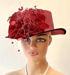 The hat featured here is a small brimmed red  straw hat with a black trim. On the side of the hat is a large and plush  red flower made from a grouping of red satin petals. On top of these petals is a draped red appliqué. Sewn onto this ted fabric are red sequins and red balls. Several strands of clear thread with red beads hang down past the brim of the hat. This  one of a kind  hat was made by Letty in New York. Creating the look that suits you best can be achieved just by  turning the hat on your head creating a different look with each twist till you find the look you love.. This classic hat is a beautiful Church hat or a Kentucky Derby Hat.  Also perfect  for  an Easter Hat, Tea Party hat, Wedding Party Hat, Fancy Dress Hat, a gothic hat, hobo hat, and other special occasions hat. Bri Special Occasion Hats, Red Drapes, Hat Tea Party, Easter Hat, Beautiful Church, Easter Hats, Hat Wedding, Church Hat, Tea Party Hats