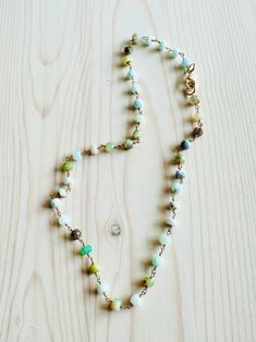 Enjoy the beauty of this handmade choker, featuring exquisite Peruvian opal stones. The chain showcases a stunning array of rich colors, from serene pale blues and aquas to vibrant greens and earthy tones. Measuring 16 inches in length with 2 " extension, this unique piece adds a touch of style to any outfit. Perfect for everyday wear or special occasions. Made with natural Peruvian Opal stones on gold over sterling silver wire. Dainty and lightweight. Natural stones may vary slightly in color. Turquoise Chalcedony Necklace With Natural Stones, Bohemian Jade Jewelry, Bohemian Single Strand Choker, Bohemian Single Strand Choker Jewelry, Bohemian Gemstone Choker Necklace, Handmade Turquoise Chrysoprase Necklaces, Artisan Necklace With Natural Stones And Amazonite, Bohemian Amazonite Crystal Necklace For Healing, Artisan Amazonite Necklace With Natural Stones