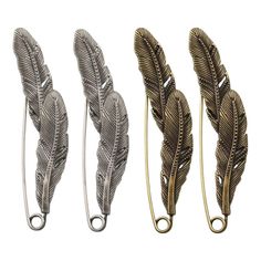 three metal feathers are shown in different sizes and shapes, one is gold and the other is silver