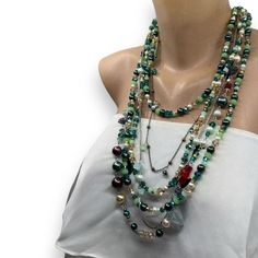 Handmade , Boho Style  Chic, Multi Strand Layered Green and Burgundy Shades Multi Color Necklace Discover this stunning multi-strand bohemian necklace featuring a vibrant mix of pearls, crystals, and semi-precious stones in rich shades of green, gold, and red.  Perfect for making a bold statement, this handmade necklace combines elegance and unique charm with its intricate design.  Whether for casual wear or a special occasion, it adds a touch of boho-chic style to any outfit. Ideal as a gift or Green Bohemian Pearl Necklace For Jewelry Making, Bohemian Multi-strand Beaded Crystal Necklace, Bohemian Beaded Layered Necklace For Party, Bohemian Beaded Pearl Necklace For Party, Bohemian Double Strand Layered Necklace For Party, Bohemian Long Pearl Necklace, Handmade Bohemian Pearl Necklace For Party, Bohemian Double Strand Necklace For Party, Bohemian Multi-strand Crystal Necklace With Colorful Beads