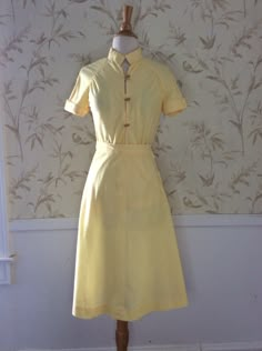 "Vintage Skirt Set 1950's Vintage Blouse and Skirt Handmade so One of a Kind It wasn't worn though. The button and buttonhole was never done Linen Look sheer Lemon Yellow Cotton Mandarin Style Blouse with Raglan Sleeves and gathering below the seam Wood Toggle buttons and loops Cuffed sleeves A Line Skirt with a size seam metal zipper No size tag, so Please go by measurements taken laid flat seam to seam 18\" armpit to armpit 25 1/2\" long 12 1/2\" waist skirt 20\" hips 25 1/2\" long Excellent V A-line Fitted Skirt With Buttons, Fitted Retro Skirt For Daywear, Retro Fitted Skirt For Daywear, Vintage Dress With Lined Relaxed Skirt, Vintage Dresses With Lined Relaxed Skirt, Summer Daywear Skirt With Buttons, Full Skirt With Button Closure And Fitted Waist, Semi-formal Summer Skirt, Fitted Full Skirt For Daywear