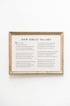 a framed poem hanging on the wall in front of a white wall with words written below it