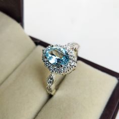 "Natural Blue topaz Ring For Women, Engagement Ring, Anniversary Ring, Best Ring For her, Jewelry for Girls, Proposal Ring, Promise Ring Specifications :- ❥ Stone - Natural Sky Blue Topaz ❥ Stone Size - 6x8mm  ❥ Cut Type - Oval ❥ Side Stones- Simulated diamonds Cz ❥ Ring Size: I offer more than one (Contact us if your ring size is not available in the listing) ❥ Color: Silver, Gold, Rose Gold, White Gold or Black Rhodium ❥ Material : 925 Sterling Silver, 14K/18K/22K Solid Gold --> ❥ Makes a Wonderful Gift for your Girlfriend, Wife, Mother and Friend or Simply an Excellent Addition to Your Jewelry Collection -->IF YOU WANT CUSTOM ENGRAVING ON YOUR RING VISIT OUR LISTING HERE: It's Only 2 USD https://www.etsy.com/listing/1436332485/custom-engaraving - -Here's a link to my HOMEPAGE: Johrifine Light Blue Jewelry With Center Stone For Promise, Light Blue Diamond Ring With Accent Stones, Light Blue Diamond Rings With Accent Stones, Aquamarine Diamond Ring With Center Stone As Gift, Blue Topaz Ring With Halo, Blue Topaz Promise Ring With Accent Stones, Blue Diamond Ring With Halo Design For Promise, Aquamarine Promise Ring With Accent Stones, Light Blue Cubic Zirconia Promise Ring