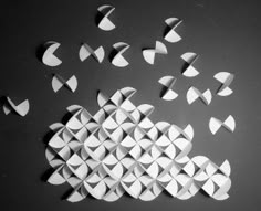 several pieces of paper are arranged in the shape of clouds