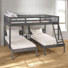 two bunk beds with white sheets and pillows