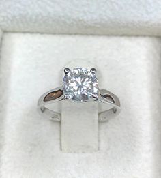 a white diamond ring in a box