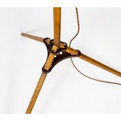 an old fashioned wooden table lamp with a chain hanging from it's base and the light turned on