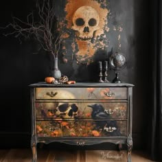 an old dresser with skulls and pumpkins painted on the drawers is shown in front of a black wall