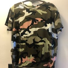 Valentino Camouflage T-Shirt Size S In Great Condition, No Damage In A Smoke-Free Home & No Smell. Has Gold Rock Stud On Top Back (Shown In Pics). Runs Small. Casual Camouflage Shirt With Graphic Print, Casual Camouflage Shirt For Summer, Casual Green Top With All Over Print, Casual Camouflage Short Sleeve Shirt, Khaki Graphic Print Short Sleeve Tops, Casual Khaki Tops With Graphic Print, Casual Camouflage Cotton Shirt, Casual Cotton Camouflage Shirt, Khaki Crew Neck Tops With Graphic Print