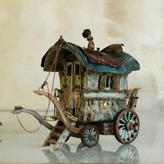 an old toy horse drawn carriage with people on top