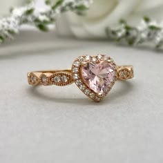 This beautiful ring is made from genuine 925 sterling silver with rose gold plating. Ring details- -The Main stone is a heart shape 6mm High Quality Lab Created Pink Morganite Stone -Side stones are round 1.5mm and 1.1mm simulated diamonds -Ring is casted in solid 925 sterling silver with rose gold plating (yellow gold and rhodium plated also available, please check the drop down menu for more options) -The Total face height of the ring measures 8mms and the band width measures 2mms -Each ring i Pink Heart Rings, Cute Promise Rings, Heart Wedding Rings, Gold Heart Ring, Heart Engagement Rings, Simulated Diamond Rings, Ring Halo, Engagement Ring Shapes, Rose Gold Heart