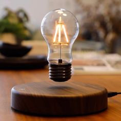 a light bulb sitting on top of a wooden table