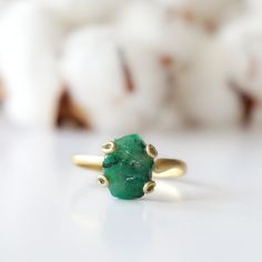 Dark green and gold create an emerald ring that sings with elegance and stands for bravery. The adjustable ring easily fits various ring sizes. The 14k gold filled metal setting creates a long-lasting and hypoallergenic ring. Each handmade pair uses a three step adhering process to guarantee durability and quality, Hypoallergenic material guarantees no reaction when you wear them. As no raw stone is the same, each emerald ring has a slightly different shape and size guaranteeing uniqueness and i Green Dainty Jewelry For Promise, Adjustable Fit Emerald Ring, Green Emerald Promise Ring With Ethical Gemstones, Dainty Gold Emerald Ring For May Birthstone, Adjustable Open Emerald Ring For Promise, Green Emerald Open Ring Stackable Rings, Adjustable Emerald Promise Ring, Green Open Ring Stackable Rings For May Birthstone, Green Emerald Stackable Open Rings