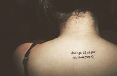 the back of a woman's neck with a tattoo saying, don't go it