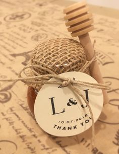 a wooden toothbrush sitting on top of a table next to a thank you tag