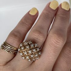 This is a fun cluster seed Pearl ring with nice finger coverage! A great statement ring crafted in 14K Yellow gold, circa 1950s. Each pearl is securely held with organic looking prongs. The shank has a nice split on the sides and tapers down to 2.68 mm at the bottom. This is the perfect ring for the lady born in June. 7.28 grams 14k yg People have coveted natural pearls as symbols of wealth and status for thousands of years. A Chinese historian recorded the oldest written mention of natural pear Vintage Gold Multi-stone Cluster Ring, Vintage White Cluster Diamond Ring, Vintage Multi-stone Pearl Ring For Anniversary, Vintage Cluster Rings For Gifts, Vintage Yellow Gold Cluster Ring, Vintage Yellow Gold Cluster Jewelry, Vintage Cluster Rings As Gift, Vintage Ring Jewelry For Vintage Events, Heirloom White Cluster Ring