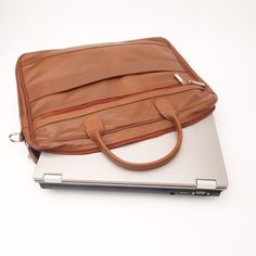 Made for men and women, our Executive Leather Laptop Bag is all about upgrading your work look .High Quality Bags with maximum functionality and minimal design to carry your laptop, files ,documents in a minimal possible way.Features ﻿ Crafted with 100% genuine Cow leather Laptop Compartment Size: Upto 15.5 inch Removable, adjustable padded shoulder strap Rear smart zipper allows you to attach this bag to the extended handles of rolling cases Main compartment has two large sections with one pock Professional Leather Briefcase For Daily Use, Professional Leather Laptop Bag For Everyday Use, Professional Bags With Leather Lining For Everyday Use, Professional Brown Laptop Bag For Everyday Use, Professional Laptop Bag With Leather Lining For Everyday Use, Leather Laptop Bag With Luggage Sleeve For Office, Professional Satchel With Leather Lining, Office Leather Laptop Bag With Luggage Sleeve, Professional Leather Laptop Bag With Luggage Sleeve