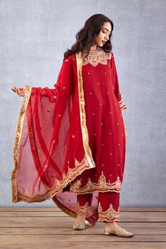 Editor's Note Featuring a bright red golden thread embroidered bandgala kurta set in raw silk along with sheer dupatta in silk organza Color: Red Fabric: Raw silk, cotton voile, silk organza Components: Kurta, dupatta and pant Embroidery details: Hand embroidery, dori and hand adda work Fit: Relaxed Occasion: Festive Care: Dry Clean Only About the Designer Torani by Karan Torani stands handcrafted luxury inspired by the myriad tales of Indian mythology. Torani is a potpourri of all things nostal Batik Fashion, Embroidery Suits Design, Boutique Dress Designs, Straight Kurta, Pattern Embroidery, Organza Dupatta, Kurta With Pants, Embroidery Suits, Silk Embroidery