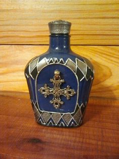 a blue glass bottle sitting on top of a wooden table