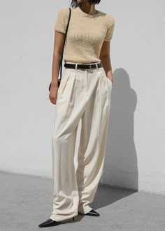 Color: Cornsilk Lightweight woven fabric Relaxed silhouette Wide leg Belt loops Pleated detailing Side hip pockets Illusion welted back pocket Double hook and bar tab closure Zip fly Unlined 75% Polyester 25% Rayon Dry Clean By The Frankie Shop. Imported Linen Trousers Street Style, Trouser Pants Outfits Summer, Summer Knit Outfit, European Summer Street Style, Business Casual Young Women, Chic Wide-leg Pants With Belt, Styling Trousers Women, Chic Belted Trousers, Fancy Lunch Outfit