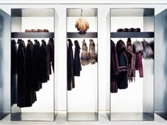 two mirrored closets with coats and jackets in them