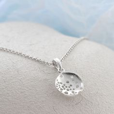 Our Wonderful Sterling Silver Bubble Dish Necklace uses a beautiful abstract design to create a truly interesting piece of jewellery . This gorgeous sterling silver necklace is perfect for people who like their jewellery with extra design and flare. This necklace can be made even more personal by the addition of some initial letter charms or a key and pearl combination. Why not complete the set with our matching sterling silver swirling waves earrings. All Martha Jackson jewellery comes complete with a gift box and blank gift card for you to write a short message on  Made from: Sterling silver Dimensions Pendant/earring diameter 1.9cm available on either a 40-45cm, 50cm or 61cm belcher chain. Add on key charm 1.3x0.5cm. Letter charms vary in size from 1cm to 1.5cm long. Nickel-free Drop Sterling Silver Necklace, Sterling Silver Drop Necklace Nickel Free, Sterling Silver Drop Necklace With Large Pendant, Sterling Silver Hallmarked Round Pendant Necklace, Drop White Gold Sterling Silver Necklaces, Sterling Silver Drop Necklaces, Sterling Silver Drop Necklace With Polished Finish, Unique Silver Drop Necklaces, Unique Silver Drop Necklace