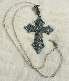 Add a touch of Southwest charm to your collection with this stunning Montana Silversmith Turquoise Cross necklace on a Pandora oval link chain. Perfect for birthdays, anniversaries, or just because you want to treat someone special. The porcelain case adds a unique touch to this elegant piece. #MontanaSilversmiths #Pandora #TurquoiseCross #SouthwestCharm #FashionAndCostumes #Religious #Western #Beauty #BlueAndSilver #22inChain #LobsterClosure #Signed #FloatingKeepsake #Porcelain #Necklace Necklaces Western, Western Cross Necklace, Turquoise Cross Necklace, Turquoise Cross Pendant, Porcelain Necklace, Western Cross, Cowgirl Jewelry, Turquoise Cross, The Wild West