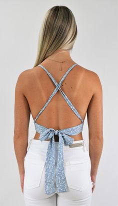 Great trendy little top. This tiny triangle crop top has adjustable straps that cross in the back for support and a back tie that customizes the fit. Wear it with a skirt for a delicate look, or pair it with your favorite jeans to add some edge. Color-Light Blue Floral (Also available in Gold Floral) 100% Rayon Chic Crop Top With Built-in Bra And Strappy Back, Casual Crop Top With Built-in Bra And Strappy Back, Spring Tops With Built-in Bra And Strappy Back, Spring Beach Crop Top With Built-in Bra, Chic Strappy Back Crop Top For Spring, Chic Triangle Crop Top With Built-in Bra, Summer Chic Tops With Strappy Back, Summer Tops With Adjustable Cross-back Straps, Spring Cross Back Tops With Adjustable Straps