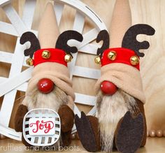 two brown and white stuffed animals with red noses, nose rings and bells on their heads